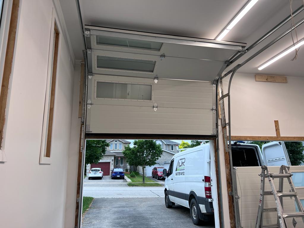 Modern garage door with tinted windows installed at a residential home