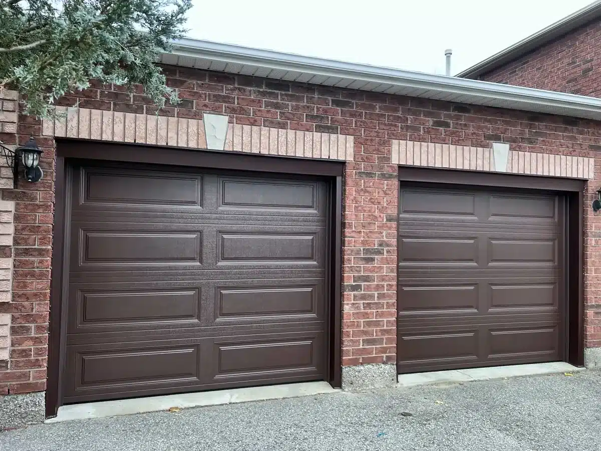 Two brown insulated garage doors without windows installed by ADR
