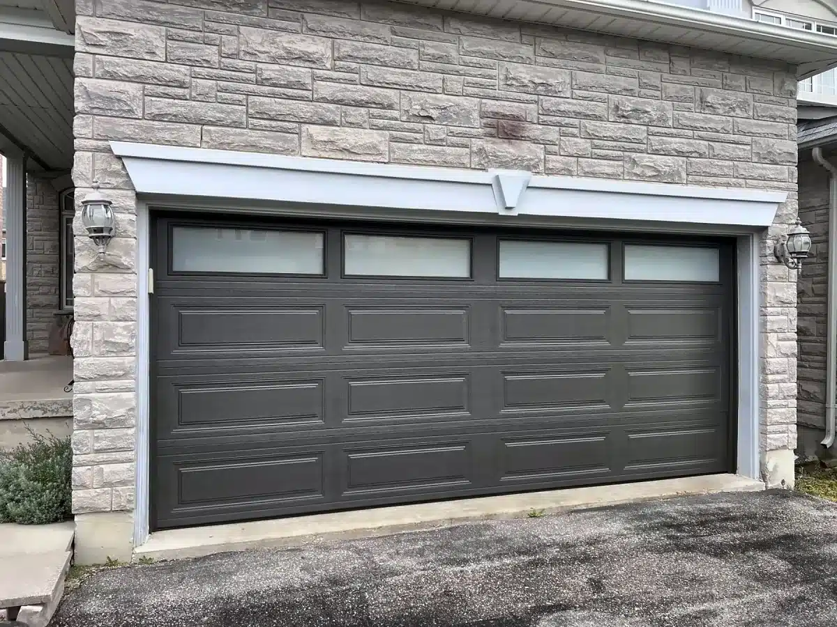 Charcoal long-panel garage door with top windows installed by ADR