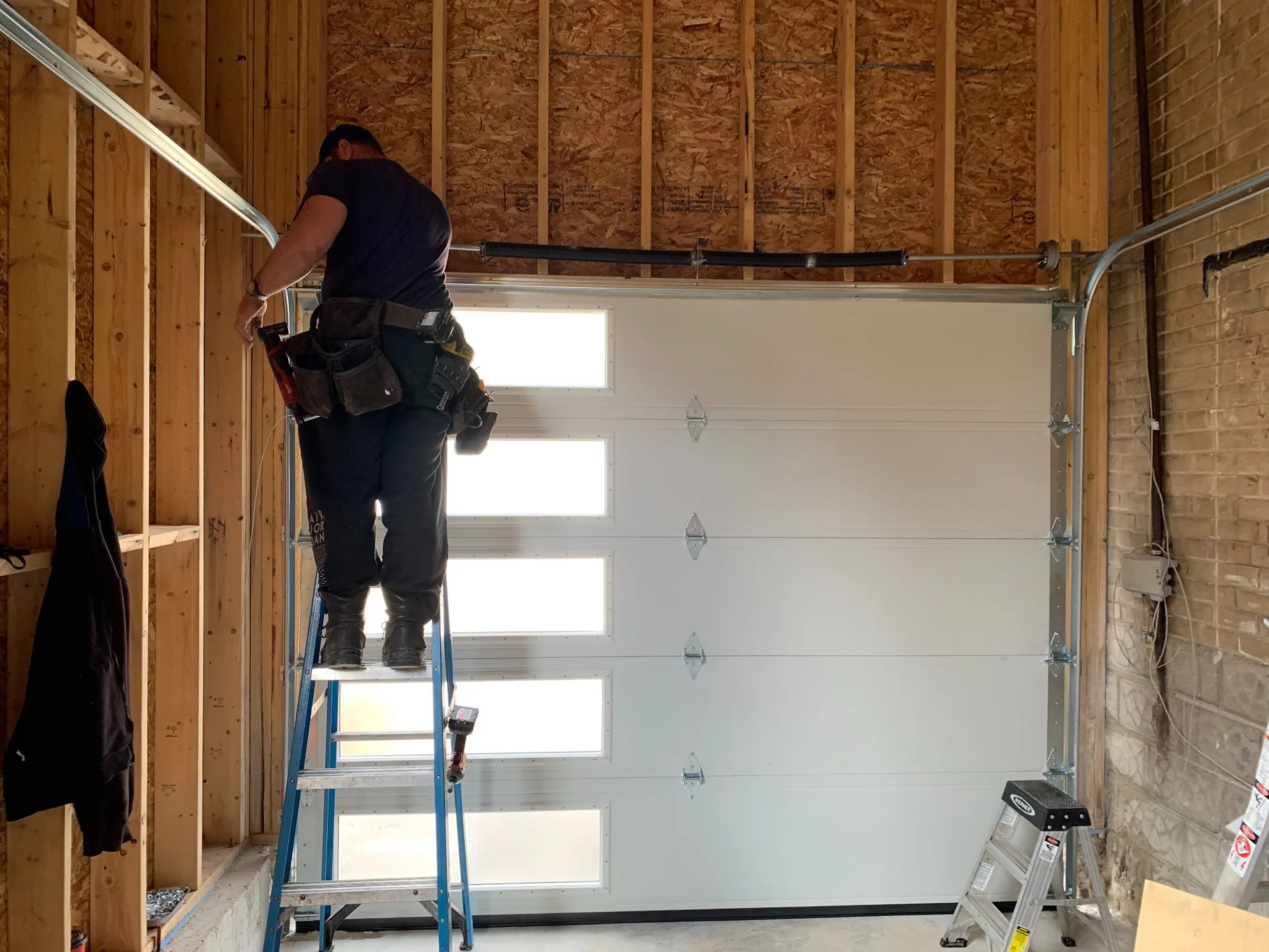 ADR Garage Door technician repairing a residential garage door in Barrie