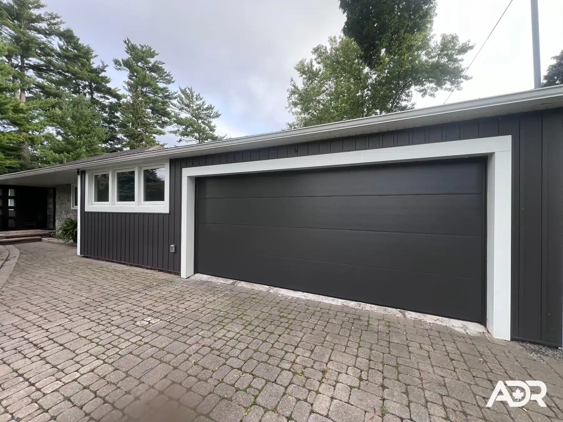 Modern black flush double garage door after installation